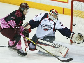 Windsor goalie Brendan Johnston, right, makes a save on Peterborough's Josh Maguire during the Petes' 6-3 victory in Peterborough Saturday. (Courtesy of Cliff Skarstedt)