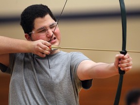 Western Secondary School  student Samuel Oliva, 17, takes aim during an archery lesson at the school.