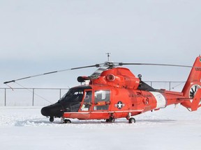 A US Coast Guard helicopter helped rescue two snowmobilers after falling into Lake Erie south of Kingsville on Saturday, Feb. 14, 2015. (DAX MELMER/The Windsor Star)