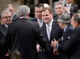 Foreign Minister John Baird is congratulated in the House of Commons in Ottawa on Tuesday, Feb. 5, 2015 after announcing his resignation. THE CANADIAN PRESS/Adrian Wyld