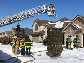 Windsor firefighters are shown at the scene of a house fire in the 4200 block of Barton Crescent on Monday, Feb. 23, 2015, in Windsor, Ont. (DAN JANISSE/The Windsor Star)