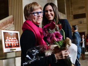 Lee Carter, left, and Grace Pastine, litigation director of the British Columbia Civil Liberties Association, smile inside The Supreme Court of Canada, Friday morning, Feb. 6, 2015, in Ottawa, Ontario. Canada's highest court Friday, unanimously struck down a ban on doctor-assisted suicide for mentally competent patients with terminal illnesses. Carter and her husband accompanied her 89-year-old mother Kathleen (Kay) Carter, who suffered from spinal stenosis, to Switzerland in 2010 where assisted suicide is legal, to end her life. (AP Photo/The Canadian Press, Sean Kilpatrick)