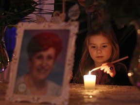 WINDSOR, ONT.: (2/7/15) -- A little girl lights a candle for Olga Rea, Saturday, Feb. 7, 2015 at the Ciociaro Club. Rea was honoured at In Honour of the Ones We Love, an event commemorating those who have lost the battle with cancer. (RICK DAWES/The Windsor Star)