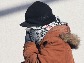 A bundled up pedestrian walks in downtown Windsor, Ont. on Monday, Feb. 23, 2015. Below seasonal temperatures are expected to stick around for several more days. (DAN JANISSE/The Windsor Star)