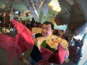 Jason Chau displays an assorted seafood in a bird's nest chinese dish at Dragon's Inn Chinese Restaurant at 2240 Wyandotte Street west in Windsor, Ontario on February 18, 2015.   Restaurants in the area are packed during Chinese new year.  Dragon's Inn is well known for their Chinese seafood dishes. (JASON KRYK/The Windsor Star)