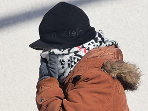 A pedestrian is dressed appropriately for the weather on a sidewalk in downtown Windsor on Feb. 23, 2015. (Dan Janisse / The Windsor Star)