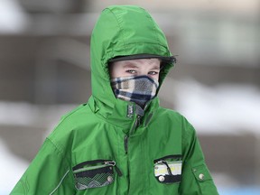 Hayden Major, 11, covers most of his face to protect himself against the cold while skating at Charles Clark Square, Monday, Feb. 16, 2015. (Dax Melmer/The Windsor Star)