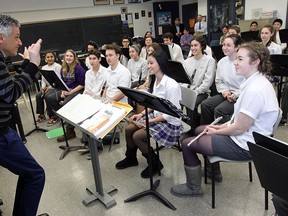 Robert Franz, Music Director with the WSO, works the the Assumption College Catholic High School band in Windsor on Thursday, February 12, 2015. Franz spent an hour with the students helping them to with technique. (TYLER BROWNBRIDGE/The Windsor Star)