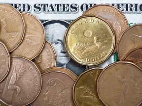 Canadian dollars on a U.S. dollar are shown in this January 2015 file photo. (Paul Chiasson / Canadian Press)