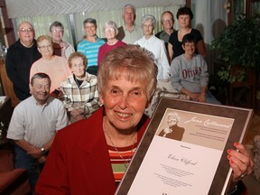Eileen Clifford displays her June Callwood Outstanding Achievement Award for Voluntarism along with a group of Essex Area Food Bank volunteers Friday at her home in Essex.   The award was presented to Eileen Clifford in Essex after she was unable to make the initial awards presentation in Toronto as she was caring for her late husband Edwin.   Cliffords award recognizes her fifty-plus years of volunteering.   She has ran the Essex Area Food Bank for the last 12 years.  (Jason Kryk/ The WIndsor Star)