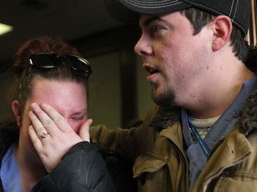 Everest College student Amanda Hunter (left) is comforted by fellow student Bobby Knight on Feb. 19, 2015. (Jason Kryk / The Windsor Star)