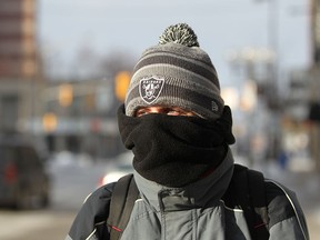 Steven Kessel, a research associate at the University of Windsor bundles up while riding his bicycle to work during the extreme cold temperature on February 12, 2015.  (JASON KRYK/The Windsor Star)