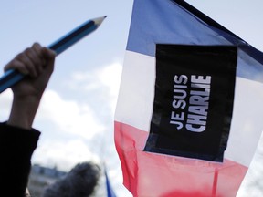 In this file photo, a demonstrator holds up an oversized pencil at Republique Square, Paris, before the start of a demonstration, Sunday, Jan. 11, 2015. When cartoonists at a French publication that had poked fun at the Prophet Muhammad were shot dead, millions around the world felt it as an attack on freedom of speech. Since the rampage, French authorities have arrested dozens of people _ including a comedian _ for appearing to praise the terrorists or encourage more attacks.  (AP Photo/Laurent Cipriani)