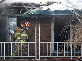 Amherstburg fire crews work at the scene of a working house fire at a home in the 1400 block of Front Road North in Amherstburg, Saturday, Feb. 28, 2015.  (DAX MELMER/The Windsor Star)