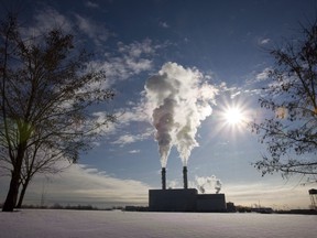 In this file photo, smoke pours from the stacks at the Portlands Energy Centre in Toronto, January 15, 2009. An environmental analyst says a new report revealing that oil and gas production has become the single biggest source of greenhouse gas emissions adds further weight to calls for Ottawa to regulate the sector. THE CANADIAN PRESS/Frank Gunn