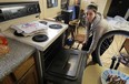 Maureen Cobb is using her oven to warm her apartment after the heat went out recently in Windsor on Friday, February 20, 2015.      (TYLER BROWNBRIDGE/The Windsor Star)