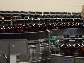 Employees keep a watchful eye on whisky bottles during the official opening of the new bottling line at Hiram Walker & Sons distillery in Windsor on Friday, February 6, 2015. (TYLER BROWNBRIDGE/The Windsor Star)