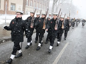 Sea cadets with the H.M.C.S Hunter march down Ouellette Ave. during a snow storm for a flag lowering ceremony outside H.M.C.S Hunter, Saturday, Feb. 14, 2015.  Windsor's Naval Reserve Division is moving to a new location on the water at 90 Mill St. after 74 years at 960 Ouellette Ave.  (DAX MELMER/The Windsor Star)