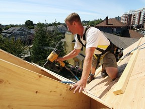 In this file photo, Phil Aitken works on the roof of a new house at 508 Pendray Ave. in Victoria, B.C., Aug. 16, 2011. Even with the best safety procedures and equipment, accidents can happen. And if a worker has an accident on the job, who's responsible? (Adrian Lam/Victoria Times Colonist)