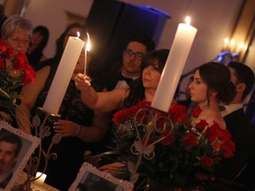 WINDSOR, ONT.: (2/7/15) -- A candle is lit in memory of John Moceri, pictured bottom left, Saturday, Feb. 7, 2015 at the Ciociaro Club. Moceri was one of three people remembered at In Honour of the Ones We Love, an event commemorating those who have lost the battle with cancer. (RICK DAWES/The Windsor Star)