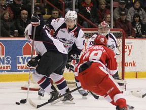 Windsor's Jamie Lewis clears a loose puck, with help from Trevor Murphy (8) in front of Spitfire goalie Brendan Johnston, as Soo Greyhounds forward Sergey Tolchinsky chases the play at Essar Centre in Sault Ste. Marie Friday, Feb. 27, 2015. (Photo courtesy Mike Verdone, Sault Star)