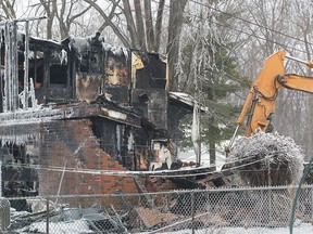 Heavy equipment is shown at the Laurier Dr. home in LaSalle, ON. on Tuesday, Feb. 17, 2015, where a fire claimed the life of a man. (DAN JANISSE/The Windsor Star)