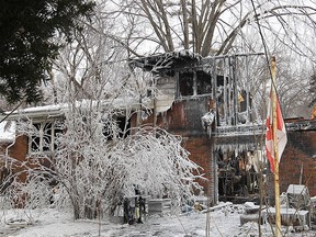 Heavy equipment is shown at the Laurier Dr. home in LaSalle, ON. on Tuesday, Feb. 17, 2015, where a fire claimed the life of a man. (DAN JANISSE/The Windsor Star)