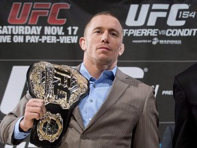 In this Nov. 14, 2012 file photo, Georges St-Pierre poses at a press conference in Montreal. St-Pierre says the current drug-testing system in mixed martial arts urgently needs fixing. THE CANADIAN PRESS/Graham Hughes