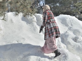 MISSISSAUGA: FEBRUARY 16, 2015 Zunera Ishaq, who wants to be allowed to wear her Niqab during the Canadian citizenship ceremony, shovels her driveway at her home in Mississauga, Ont. on Monday February 16, 2015.  (J.P. Moczulski for National Post)