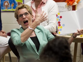 Ontario Premier Kathleen Wynne has to do more than just read to full-day kindergarten students. She has to provide adequate funding for their education. THE CANADIAN PRESS/Chris Young
