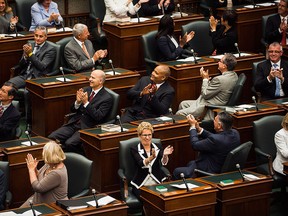 Ontario Premier Kathleen Wynne applauds along with fellow newly elected Ontario Liberal MPPs during a swearing in ceremony at Queen's Park in Toronto on Wednesday, July 2, 2014. THE CANADIAN PRESS/Aaron Vincent Elkaim