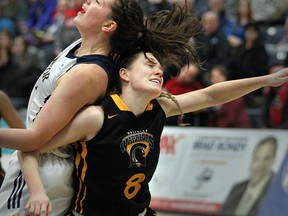 University of Windsor Lancers Andrea Kiss, left, collides with Waterloo Warriors Madison Behr during the OUA women's basketball game at the St. Denis Centre in Windsor, Ontario on Jan. 18, 2015. (JASON KRYK/The Windsor Star)