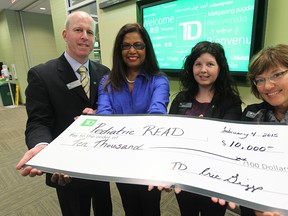 Eric Griggs  Distric V.P from TD Canada Trust, , Kay Curtis from Pediatric R.E.A.D., Ashly Flannery from TD Canada Trust, and Marie Pronovost from  TD Canada Trust during a cheque presentation in Windsor, Ontario on February 4, 2015.   (JASON KRYK/The Windsor Star)