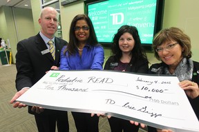 Eric Griggs  Distric V.P from TD Canada Trust, , Kay Curtis from Pediatric R.E.A.D., Ashly Flannery from TD Canada Trust, and Marie Pronovost from  TD Canada Trust during a cheque presentation in Windsor, Ontario on February 4, 2015.   (JASON KRYK/The Windsor Star)