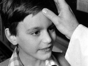 The tradition of Ash Wednesday, the beginning of Lent, was celebrated across the area on Feb. 19, 1980. Eight-year-old Jeff Watson, a Grade 3 student at St. Andrew School, receives ashes from Fr. Larry Brunet. (BEV MACKENZIE/The Windsor Star)