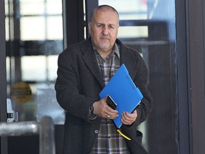 Ahmad Sannan, 49, leaves the Superior Court in Windsor, ON. on Monday, Feb. 2, 2015. He appeared on 78 fraud related charges. (DAN JANISSE/The Windsor Star)