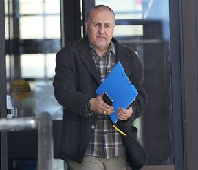 Ahmad Sannan, 49, leaves the Superior Court in Windsor, ON. on Monday, Feb. 2, 2015. He appeared on 78 fraud related charges. (DAN JANISSE/The Windsor Star)