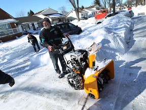 Rob Girard works his way down the street with his trusty snow blower in Windsor on Monday, February 2, 2015. Girard was kind enough to help all his neighbours clear their driveways.  (TYLER BROWNBRIDGE/The Windsor Star)