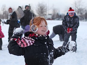Destiny Hoag, 11, takes aim with her snowball during WINsnowfight at Ford Test Track, Saturday, Feb. 21, 2015.  Approximately 100 people participated in a large snow ball fight organized by Spotted In Windsor.  (DAX MELMER/The Windsor Star)