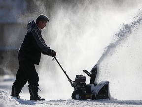 Howard Jean clears snow from his driveway on Argyle Rd. after a winter storm dumped over 30cm of snow in the Windsor region, Monday, Feb. 2, 2015. (DAX MELMER/The Windsor Star)