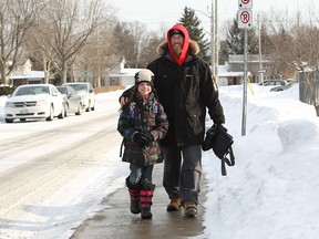 Kye Deneau walks with his daughter Ayla along Partington Avenue in Windsor on February 18, 2015.  (JASON KRYK/The Windsor Star)