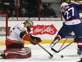 Windsor's Hayden McCool tries to get his stick on the puck in front of Belleville goalie, Connor Hicks, as the Windsor Spitfires host the Belleville Bulls in OHL action at the WFCU Centre, Sunday, Feb. 1, 2015.  (DAX MELMER/The Windsor Star)