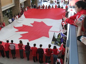 Students at St. Joseph's Catholic High School in Tecumseh unfurl a giant Canadian flag on Feb. 13, 2015. (Dan Janisse / The Windsor Star)