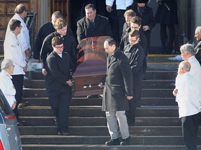 Funeral services were held for Thom Racovitis, owner of the former Tunnel Bar-B-Q on Monday, Feb. 2, 2015, in Windsor, ON. at the McEwan campus of Assumption Church. Pallbearers are carry his casket as local chefs wearing their white uniforms formed an honour guard. (DAN JANISSE/The Windsor Star)