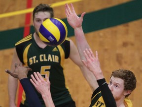 St. Clair's Connor West tries to tip the ball past Humber defenders, Matt Isaacs, left, and Patrick Richardson during OCAA men's volleyball action between the St. Clair Saints and the Humber College Hawks at the SportsPlex, Saturday, Jan. 31, 2015.   (DAX MELMER/The Windsor Star)