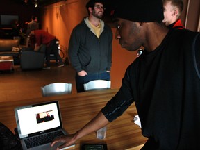 Akindele Faulkner, a University of Windsor computer science student, shows off the journalistic project he worked on with journalism student Lauren Hedges for the Press Play: Data-Journalism Hackathon event. The project pitted teams of journalism and computer science students working crunch through open data between Feb. 15 and Feb. 22, 2015.(JAY RANKIN/The Windsor Star)