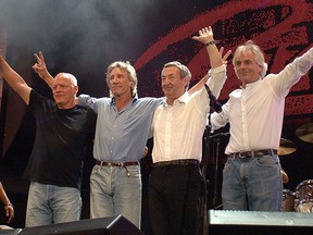 This July 2005 photo from the Live 8 concert in London shows all four members of the British rock band Pink Floyd: David Gilmour, left, Roger Waters, Nick Mason and Richard Wright. (JOHN D. McHUGH / AFP / Getty Images)