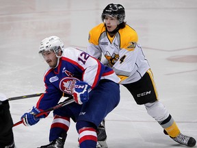 Windsor Spitfires Jamie Lewis eases into Sarnia Sting Jeff King in second period OHL action at WFCU Centre Sunday March 01, 2015. (NICK BRANCACCIO/The Windsor Star)