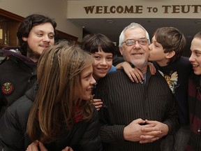 Hard luck White family gather at Windsor's Teutonia Club for a fundraiser Sunday March 01, 2015.  Joe White, 61, is surrounded by children Gary, 15, left,  John, 19, Elvis, 13, Brad, 11 and William, 15, right. (NICK BRANCACCIO/The Windsor Star)