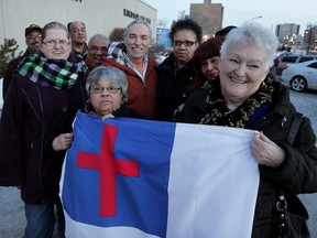 Windsor, ON. March 02, 2015 -- March For Jesus Celebration Event members Melinda Wilson, left, and Shirley Walsh hold their event flag which will not fly at City Hall following council's decision Monday, March 2, 2015.  March For Jesus Celebration Event is planned for August 22, 2015.  (NICK BRANCACCIO/The Windsor Star)